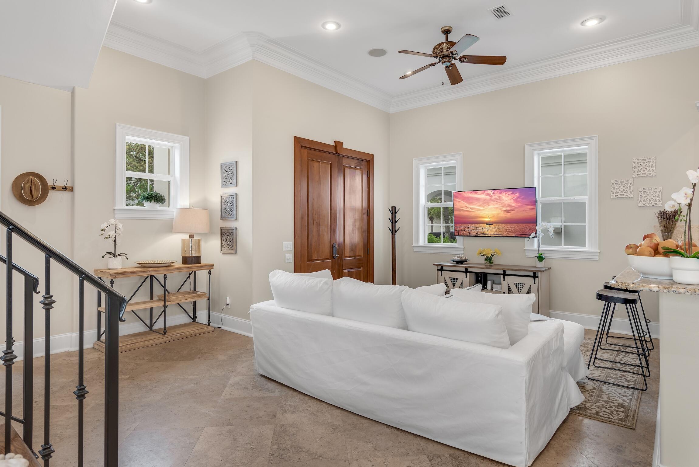 130 Palmeira Way Santa Rosa Beach, FL 32459 - Photo 6 of 38 a living room with furniture a ceiling fan and a flat screen tv