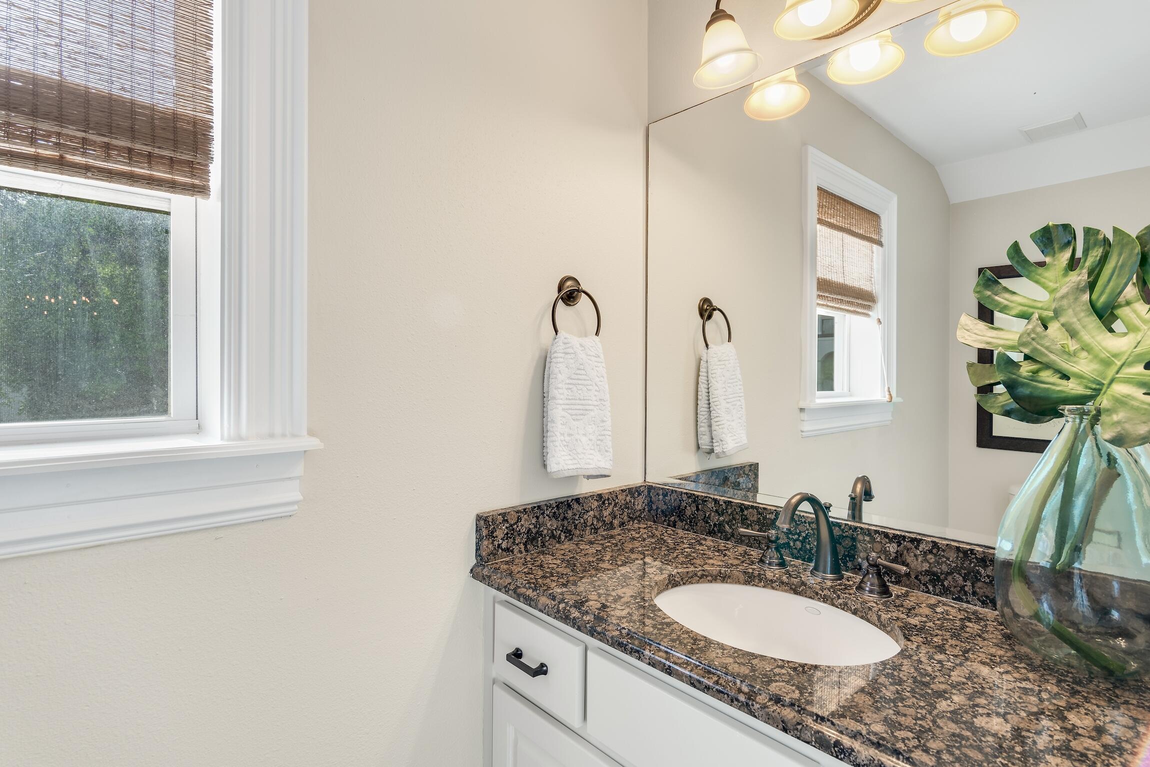 130 Palmeira Way Santa Rosa Beach, FL 32459 - Photo 8 of 38 a bathroom with a granite countertop sink a large mirror and a window
