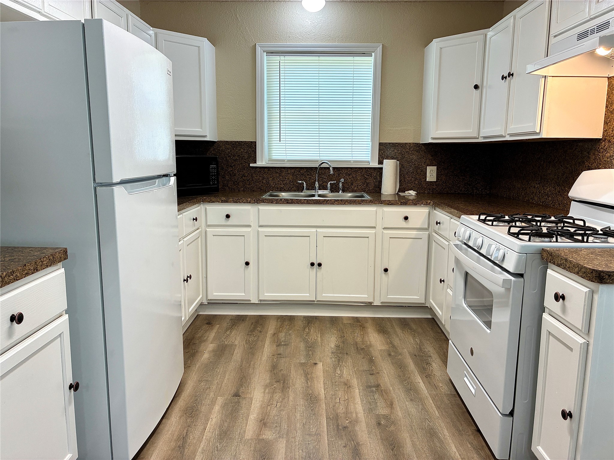 631 Roper Street Houston, TX 77034 - Photo 15 of 15 The kitchen features a new fridge, gas range, venthood, and light fixture.