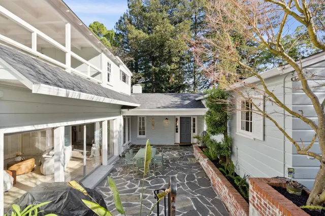 a view of a patio with table and chairs and potted plants