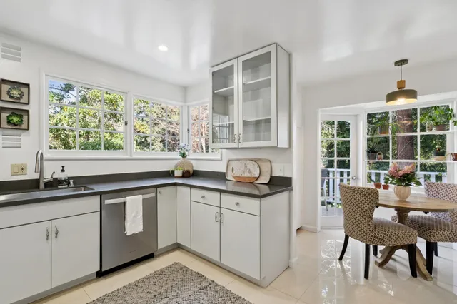 a view of a dining room with a table and chairs