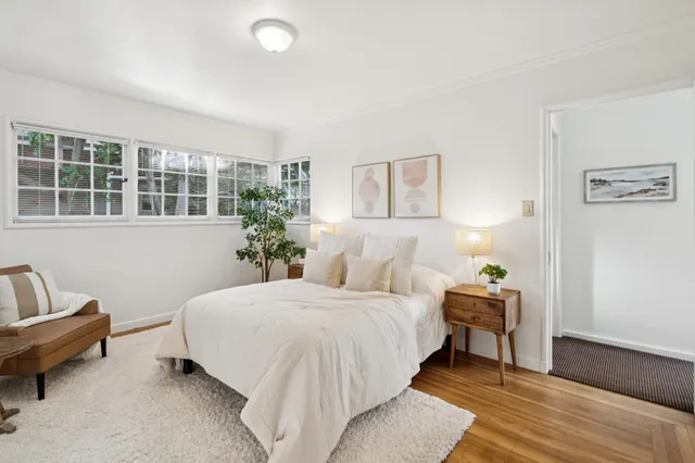 a bedroom with a large bed and a window