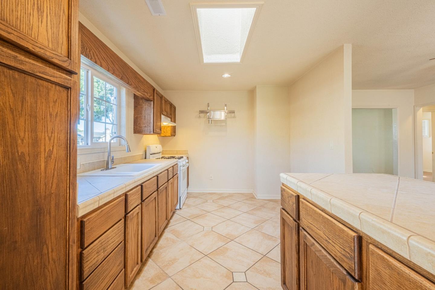 40 Oak Street Salinas, CA 93901 - Photo 12 of 28 a bathroom with a sink a vanity and mirror
