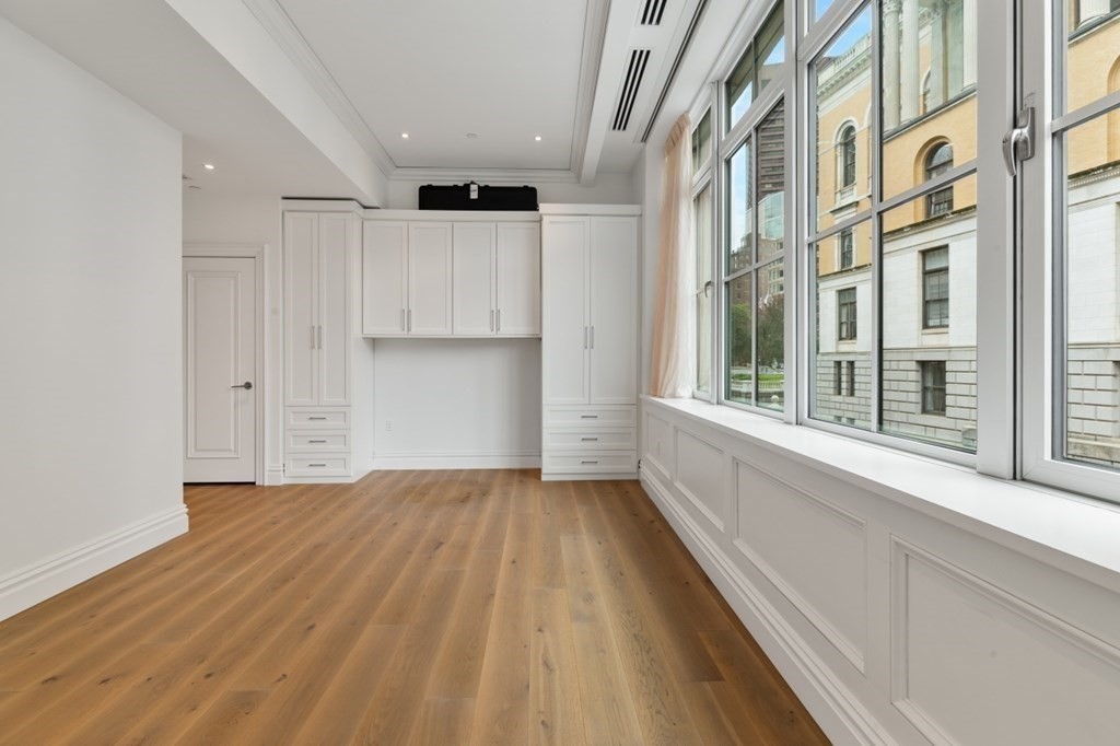 32 Derne Street, Unit 3A Boston, MA 02114 - Photo 12 of 25 a view of a big room with wooden floor and windows