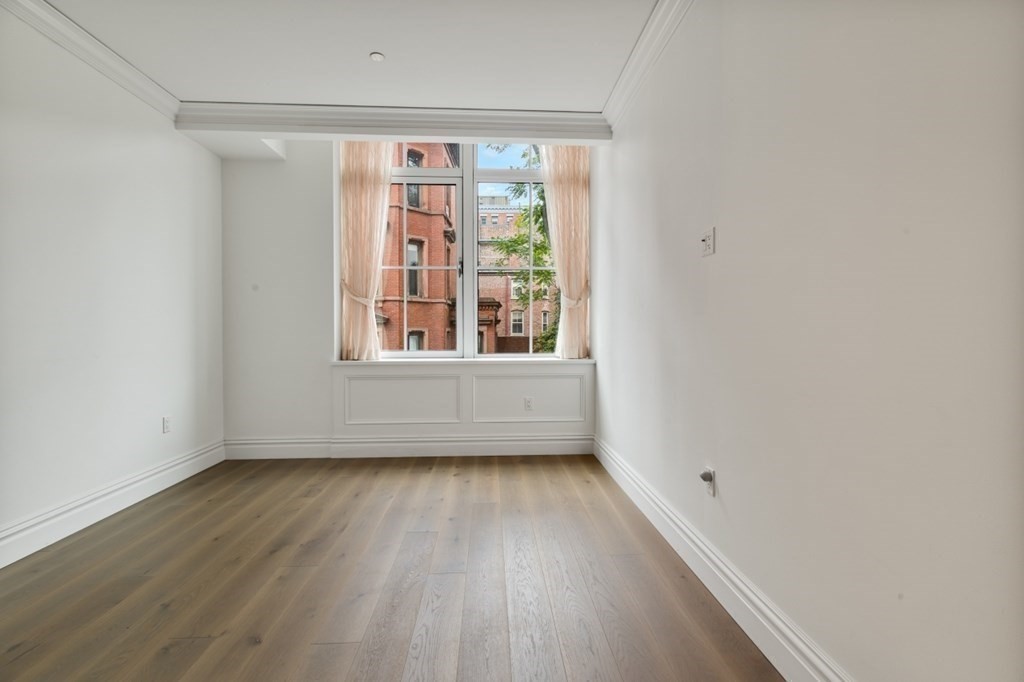 32 Derne Street, Unit 3A Boston, MA 02114 - Photo 15 of 25 a view of an empty room with wooden floor and a window
