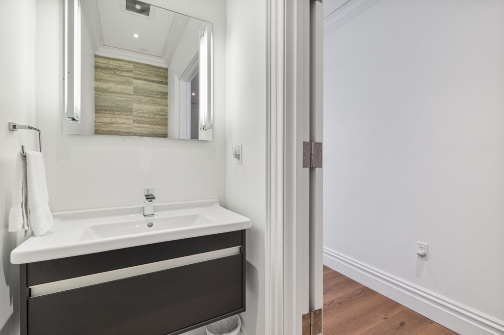 32 Derne Street, Unit 3A Boston, MA 02114 - Photo 20 of 25 a bathroom with a sink and a mirror