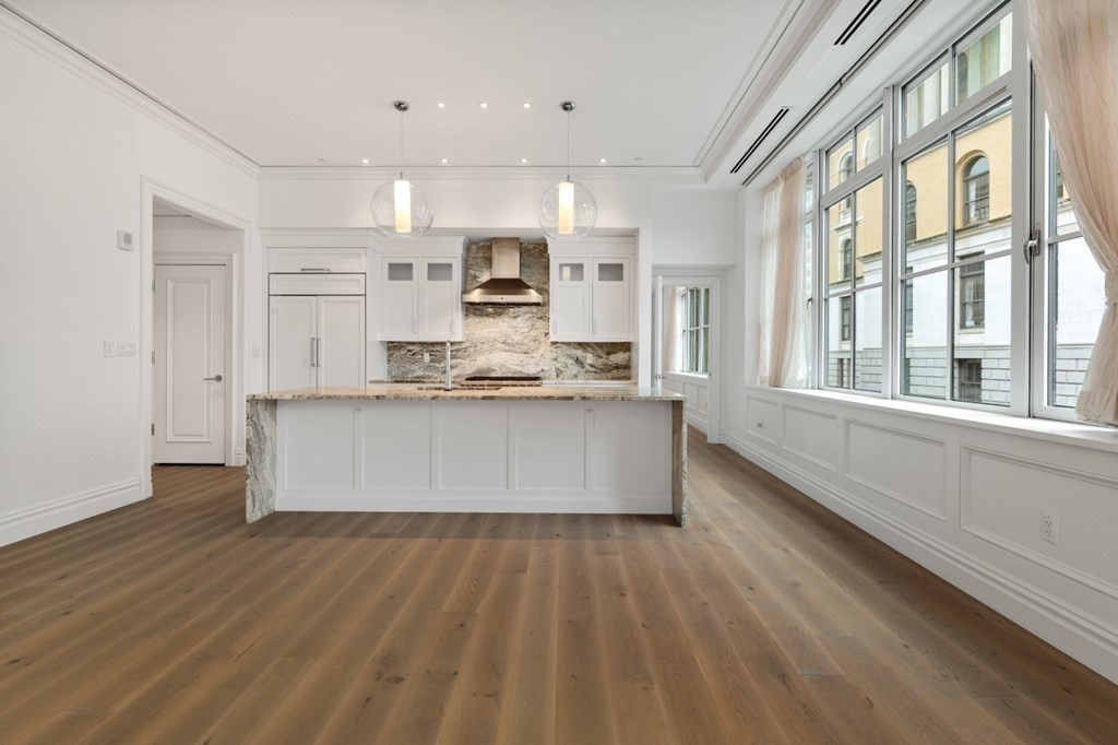 32 Derne Street, Unit 3A Boston, MA 02114 - Photo 6 of 25 a large kitchen with stainless steel appliances a large counter top and a wooden floors
