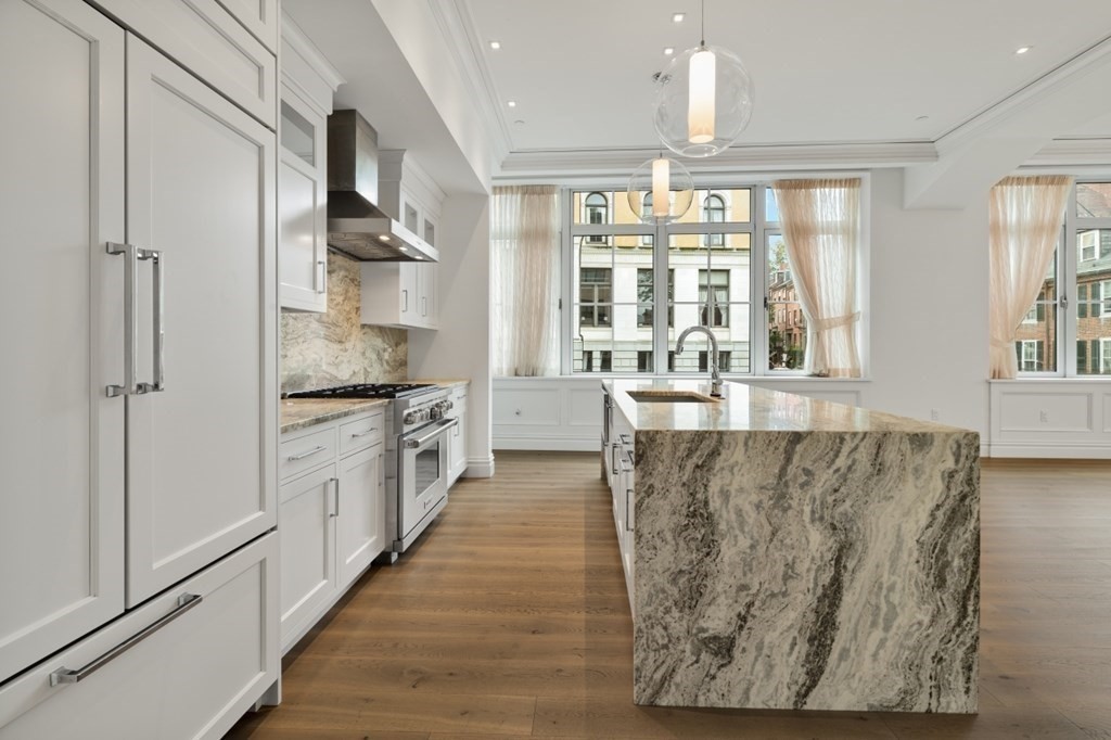 32 Derne Street, Unit 3A Boston, MA 02114 - Photo 8 of 25 a large kitchen with stainless steel appliances granite countertop a stove and a large window