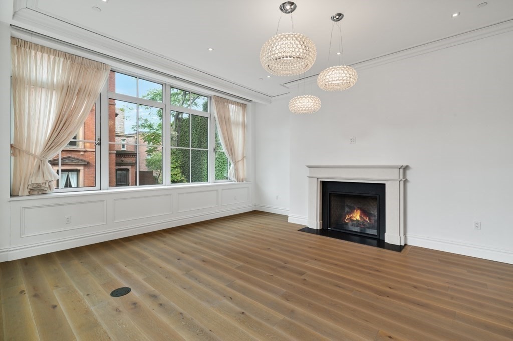 32 Derne Street, Unit 3A Boston, MA 02114 - Photo 10 of 25 an empty room with wooden floor fan and window