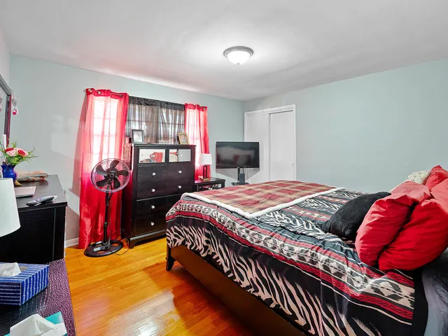 a bed sitting in a bedroom next to a window