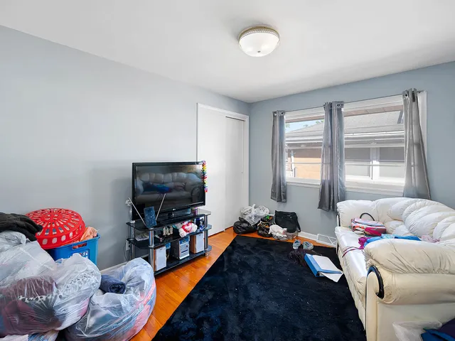 a bedroom with furniture and a flat screen tv