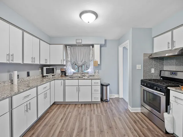 a kitchen with a sink stove and cabinets