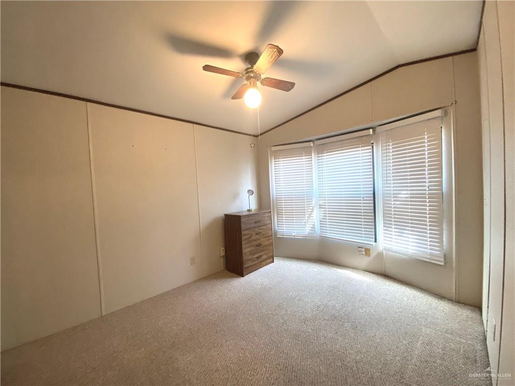 219 Bundle Wagon Drive Mission, TX 78574 - Photo 16 of 30 Unfurnished bedroom with vaulted ceiling, carpet, and a ceiling fan