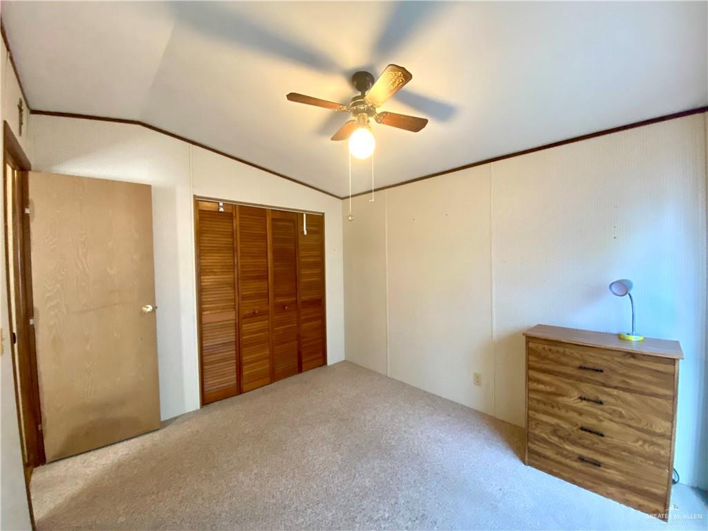 219 Bundle Wagon Drive Mission, TX 78574 - Photo 17 of 30 Unfurnished bedroom with vaulted ceiling, carpet, a closet, and ceiling fan
