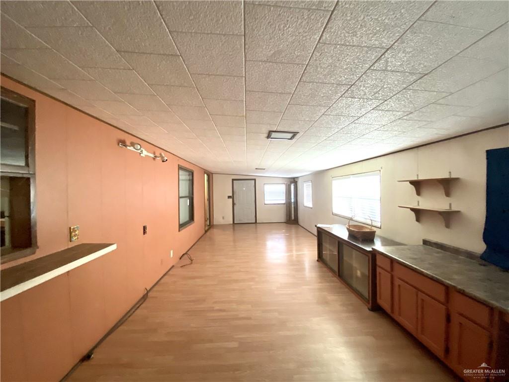 219 Bundle Wagon Drive Mission, TX 78574 - Photo 18 of 30 Kitchen with light wood-type flooring and brown cabinetry