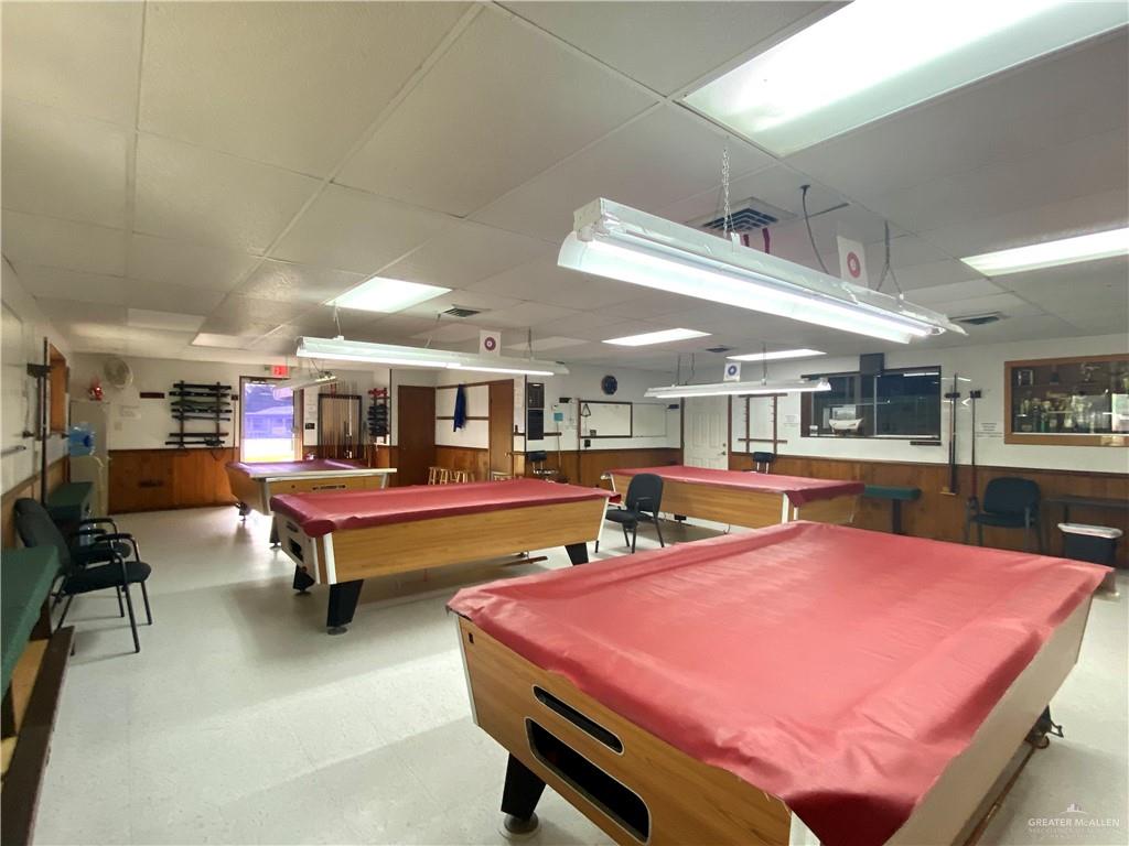 219 Bundle Wagon Drive Mission, TX 78574 - Photo 26 of 30 Playroom with pool table, a drop ceiling, wood walls, wainscoting, and tile patterned floors