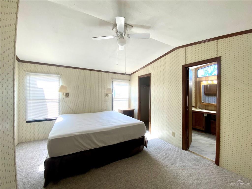 219 Bundle Wagon Drive Mission, TX 78574 - Photo 9 of 30 Bedroom featuring crown molding, lofted ceiling, light colored carpet, wallpapered walls, and a ceiling fan