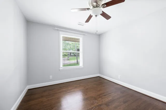 a view of hallway with window and cabinet