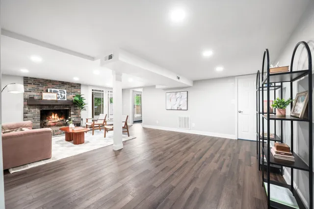 a living room with furniture and large windows