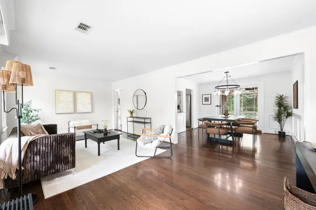 a living room with furniture dining table and wooden floor