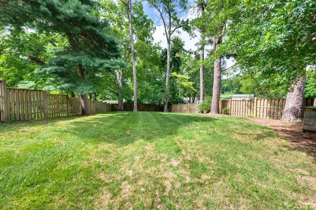 a view of a house with a backyard and a patio