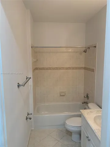 a kitchen with granite countertop a refrigerator and a sink