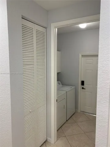 a bathroom with a granite countertop bathtub shower sink vanity and toilet