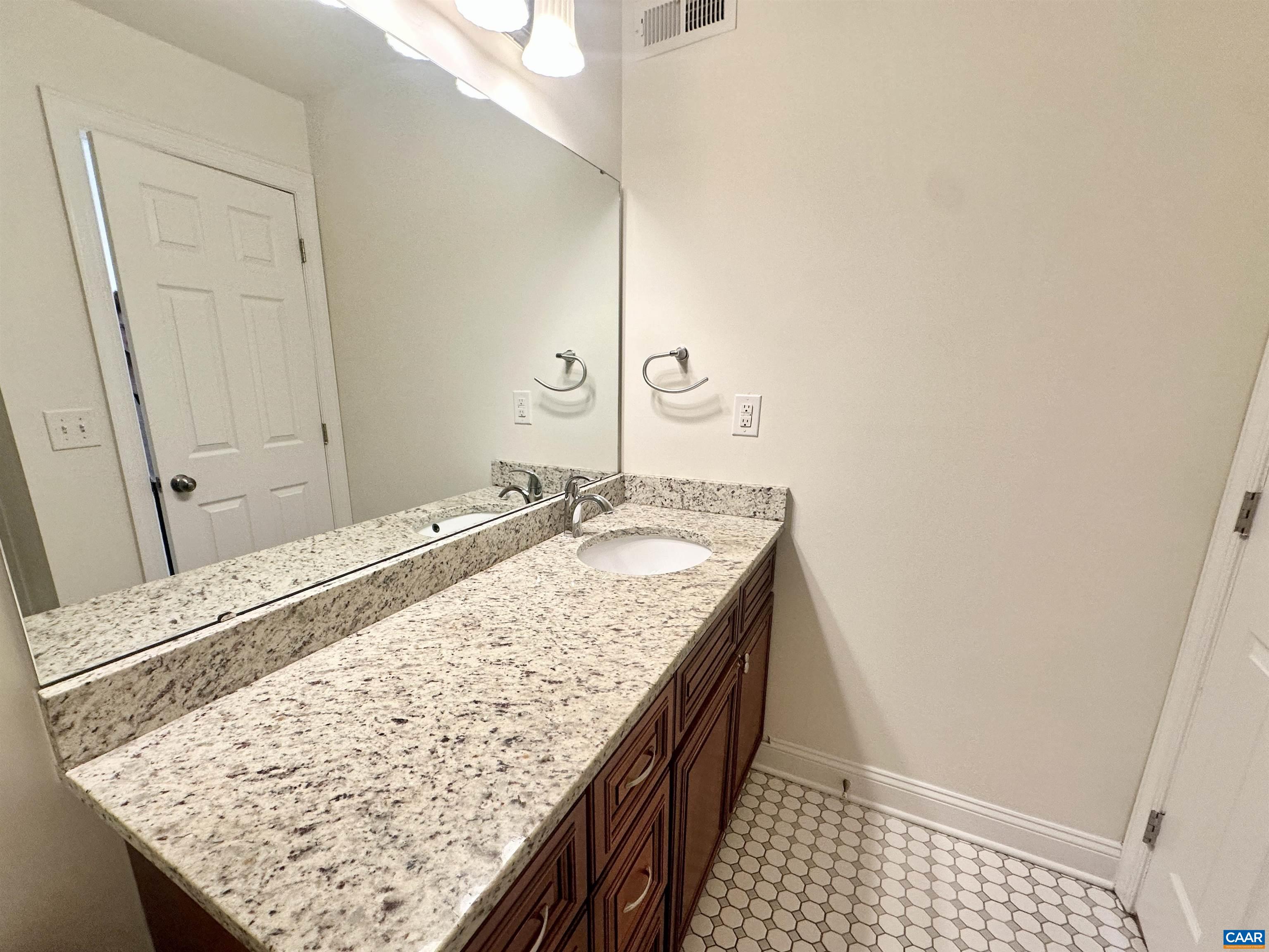 101 Turtle Creek Road, Unit 5 Charlottesville, VA 22901 - Photo 12 of 23 a bathroom with a granite countertop sink and a mirror
