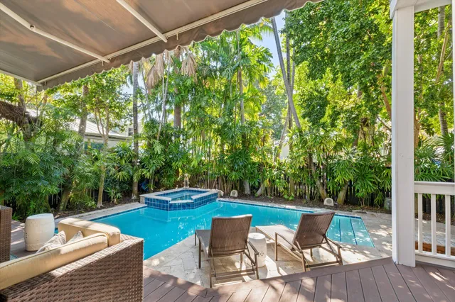 a living room with furniture and large windows