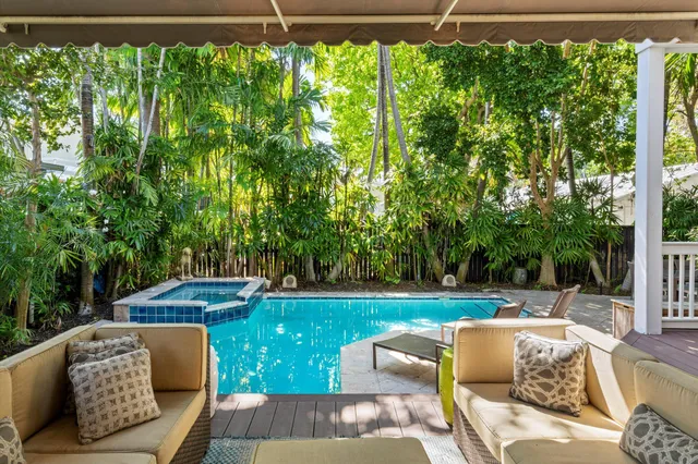 a open kitchen with stainless steel appliances granite countertop a stove and a refrigerator