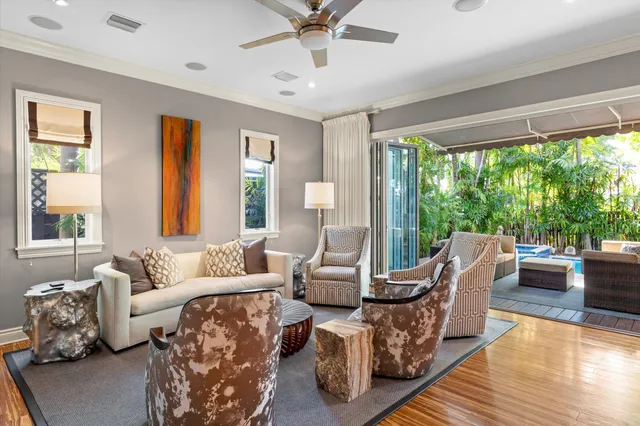 a living room with furniture a desk and chair with wooden floor