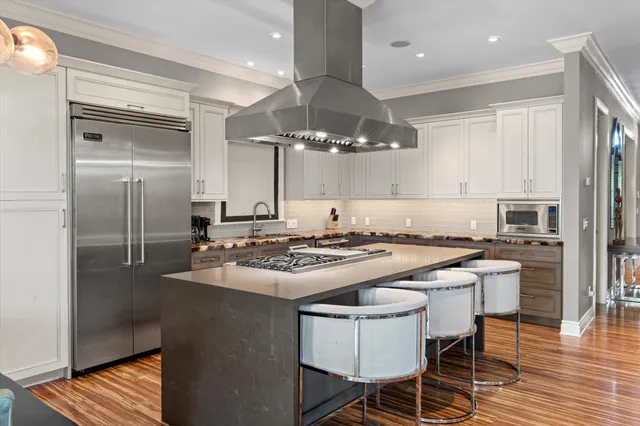 a bathroom with a granite countertop sink and a large mirror