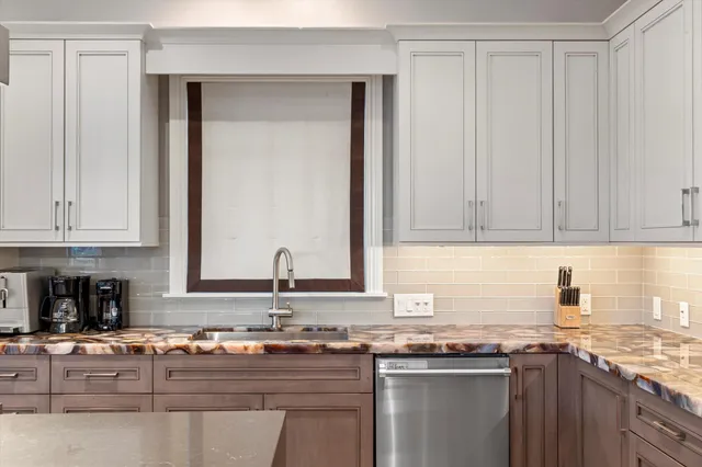 a bedroom with a bed and glass window