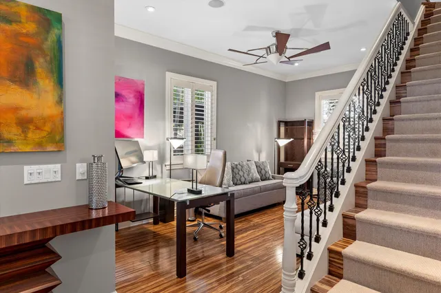 a bedroom with a bed and a painting on the wall