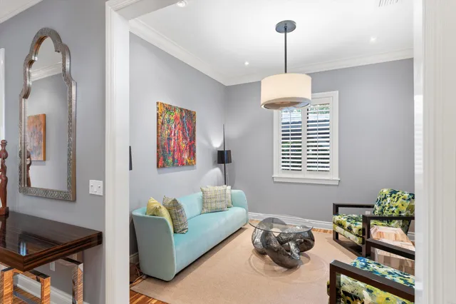 a view of a livingroom with furniture staircase and windows
