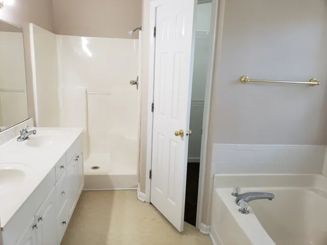 a bathroom with a tub sink and mirror