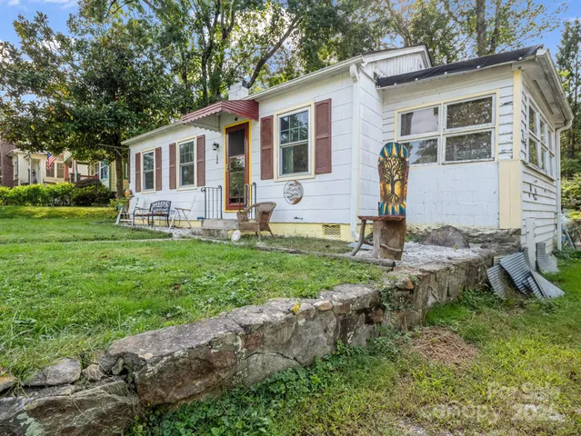 a front view of house with yard and outdoor seating