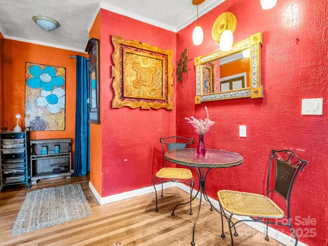 a dining room with furniture and wooden floor