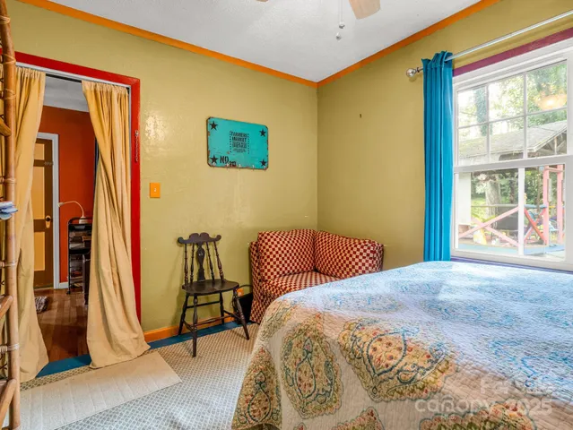 a bedroom with a bed and a large window