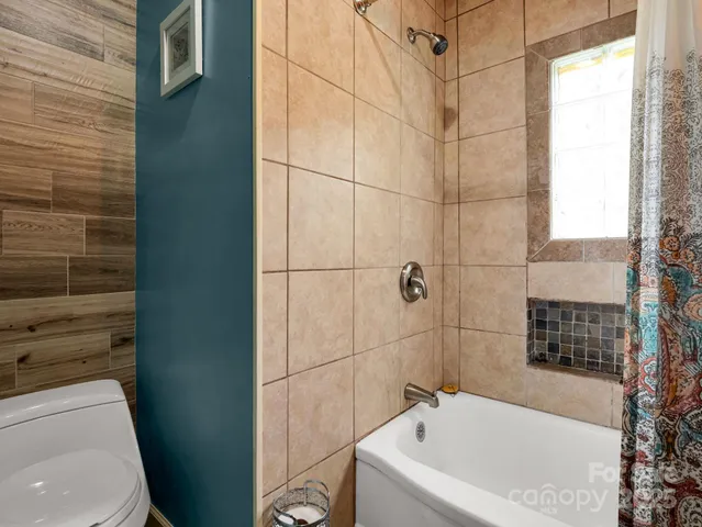 a bathroom with a bathtub and shower