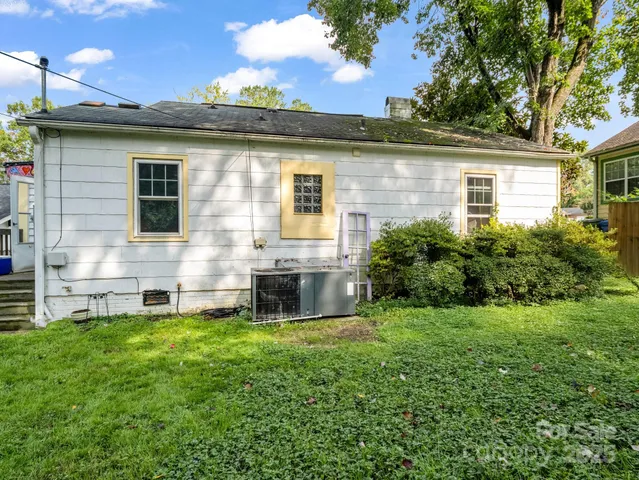 a view of house with backyard outdoor seating and hardwood