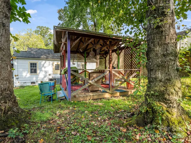 a view of a backyard with plants and a patio