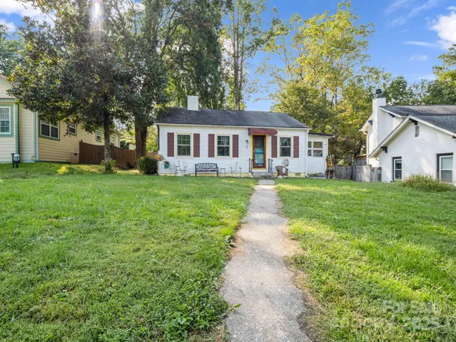 a front view of house with yard and green space