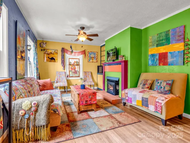 a bedroom with furniture and a large window