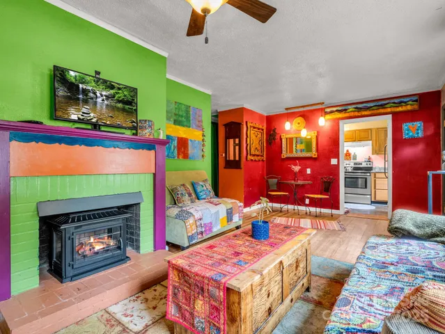 a living room with furniture a flat screen tv and a fireplace