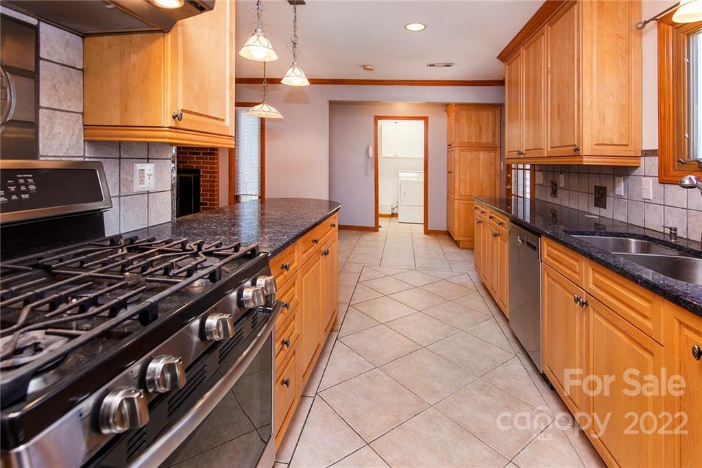 11902 5 Cedars Road Charlotte, NC 28226 - Photo 11 of 24 a kitchen with stainless steel appliances a sink stove and cabinets