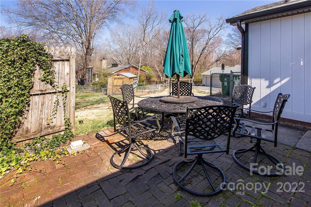 11902 5 Cedars Road Charlotte, NC 28226 - Photo 22 of 24 a view of a patio with table and chairs and potted plants