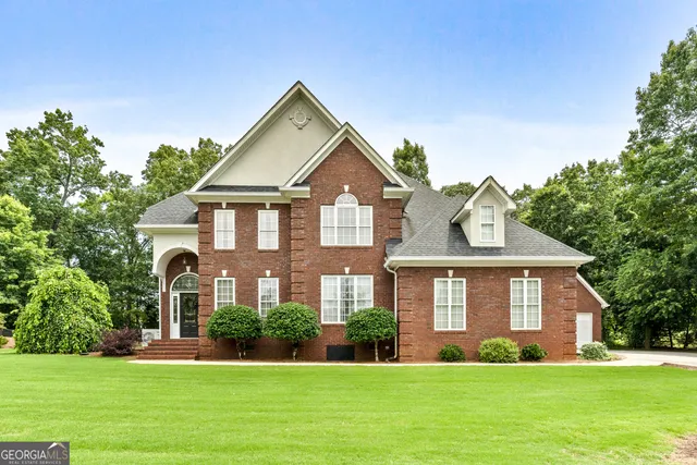 a front view of a house with a yard