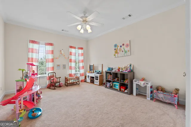 a children room with toys and a ceiling fan