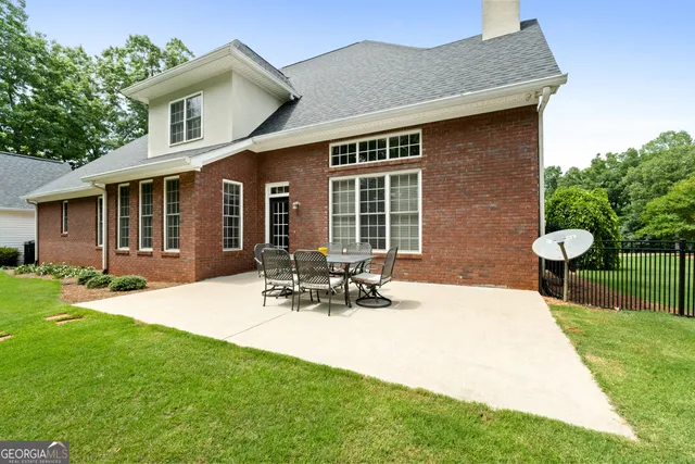 a view of a house with sitting area and garden